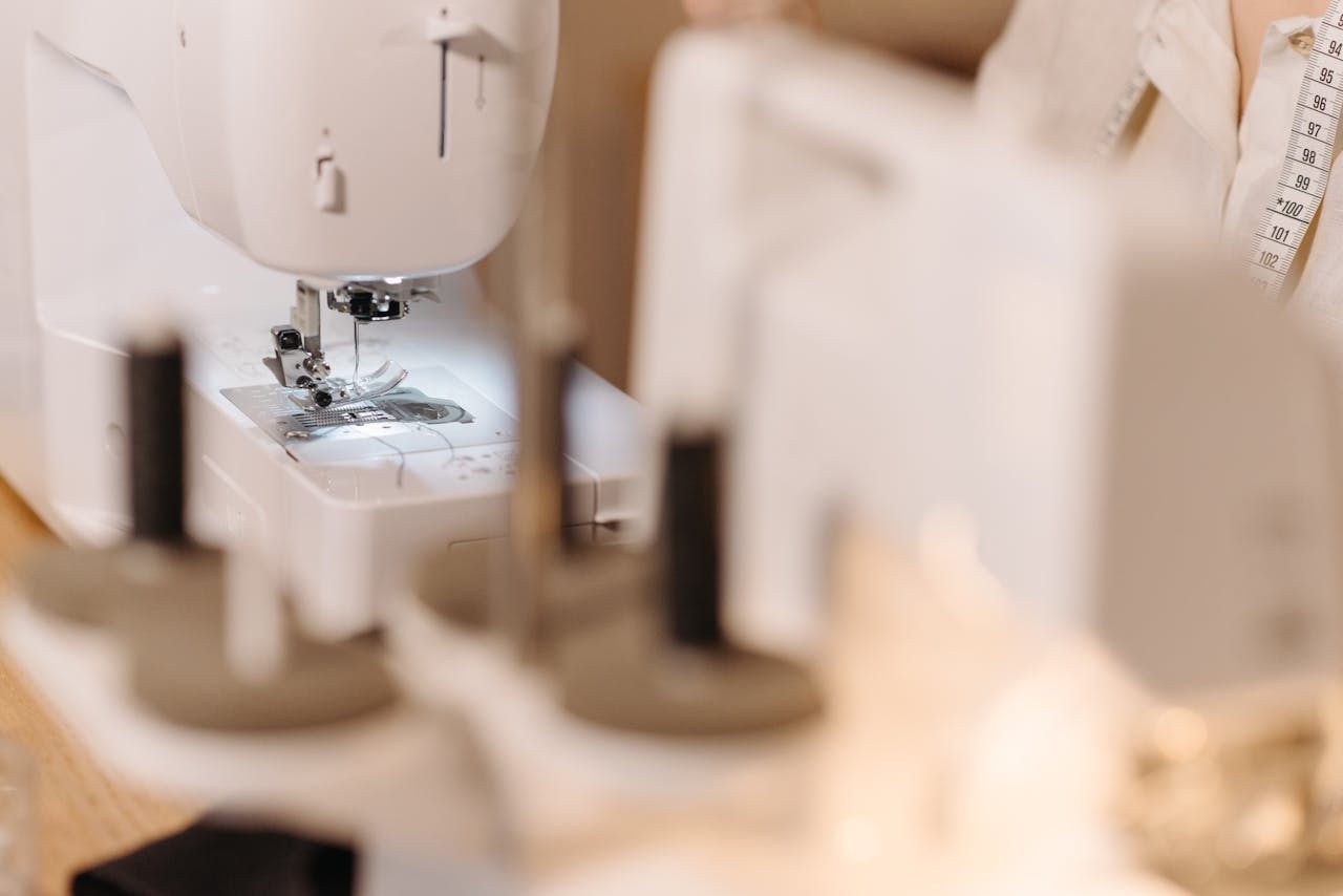 Close-up shot of a sewing machine in use, showcasing tailoring and sewing process.