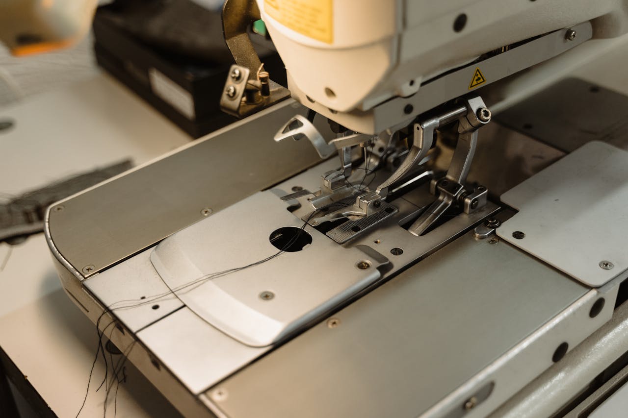 Detailed view of an industrial sewing machine, essential for garment production.